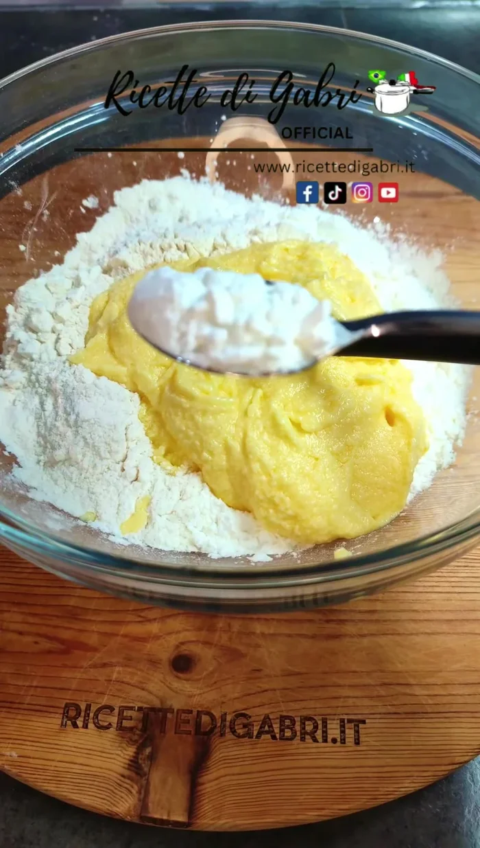 In a bowl, mix flour, cornstarch (or potato starch), the prepared mixture from the mixer, and yeast. Knead with a spoon.