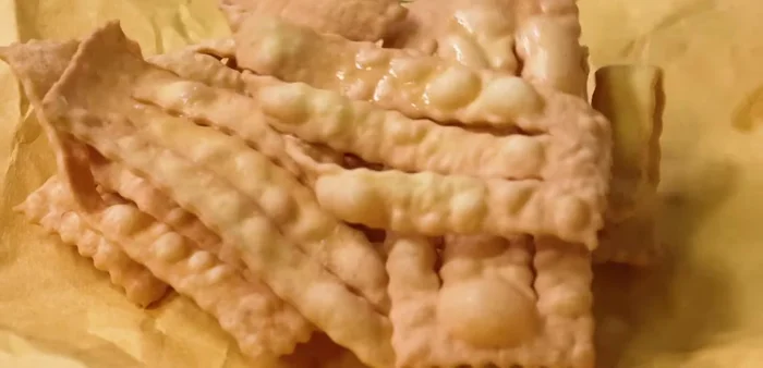 Drain on oil-absorbing paper and sprinkle generously with powdered sugar.