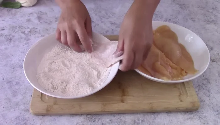 Lightly flour the chicken breast.