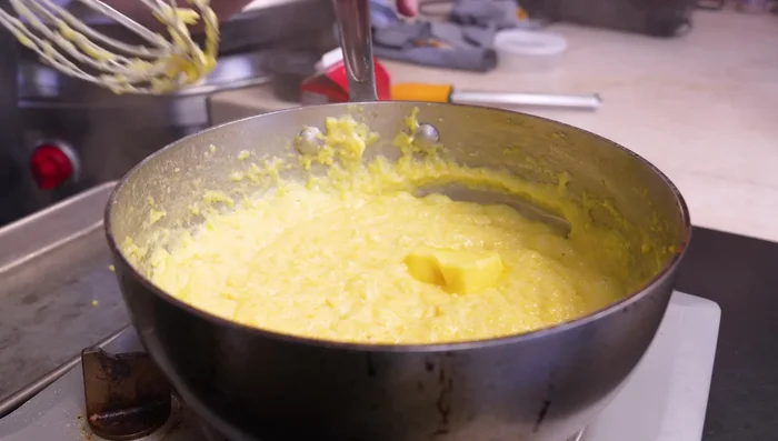 Stir in butter, parmesan cheese, ricotta cheese, and olive oil. Season with pepper.