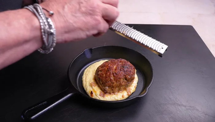 Serve meatballs over the creamy polenta. Garnish with fresh basil and parsley.