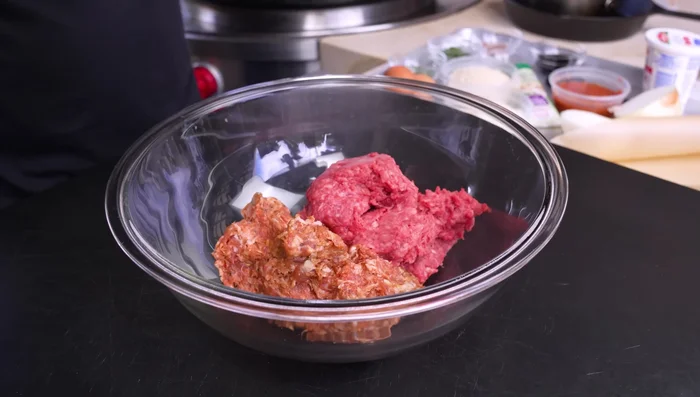 Combine all meatball ingredients (sausage, beef, garlic, breadcrumbs, salt, pepper, basil, parmesan, oregano, parsley, red pepper flakes, marinara sauce, eggs, ricotta, and grated onion) in a bowl. Mix well.