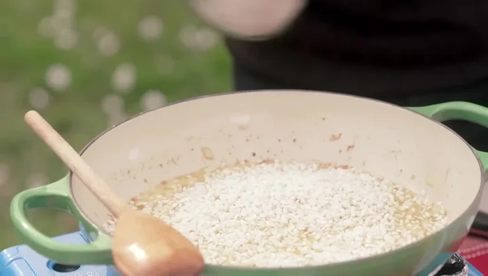 Toast rice for a couple of minutes. Add wine and let it evaporate. Add vegetable stock gradually, letting the rice absorb each addition.