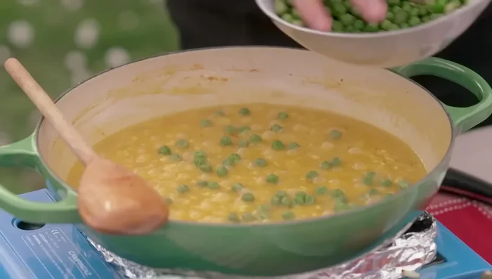 Add peas in the last few minutes of cooking. Stir in butter and cheese once the rice is cooked.