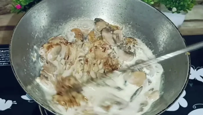 Add the fried onions, black pepper powder, and a mixture of cornflour and water. Stir well.
