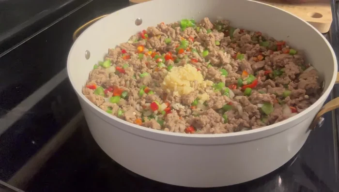 Stir in the minced garlic, Italian seasoning, salt, pepper, and granulated chicken base.