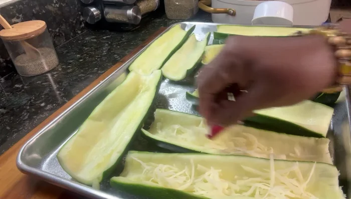 Fill each zucchini boat with a layer of mozzarella cheese, followed by the sausage mixture.