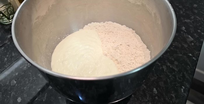 Add the wet ingredients to the dry ingredients and mix well. Add oil and knead until smooth and elastic (5-6 minutes with a stand mixer, 10 minutes by hand).