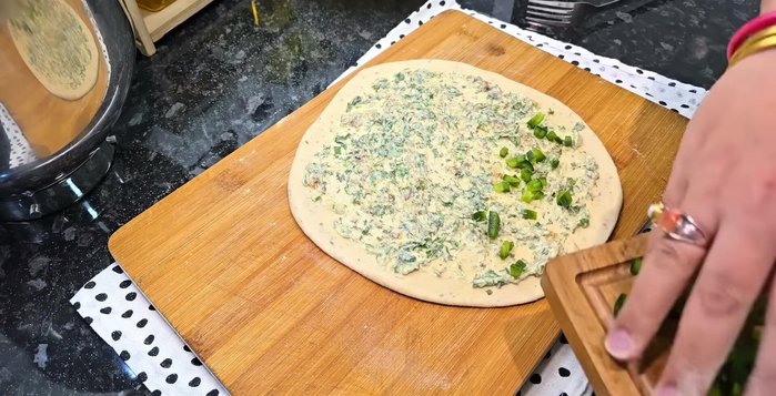 For garlic bread: Roll out dough, spread garlic butter, leaving a border. Fold in half, seal, and score.
