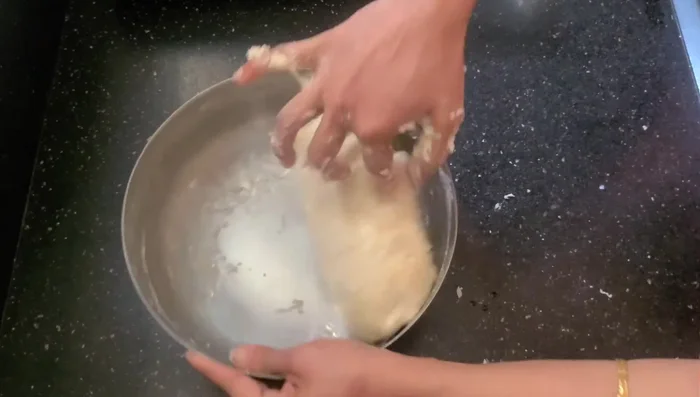Add 2 tablespoons of oil (or ghee/butter) and continue kneading for 10-15 minutes until the dough is smooth and elastic.