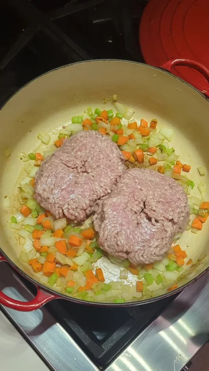 Add 1 pound of ground pork, breaking it up. Season with salt, pepper, and Italian seasoning.