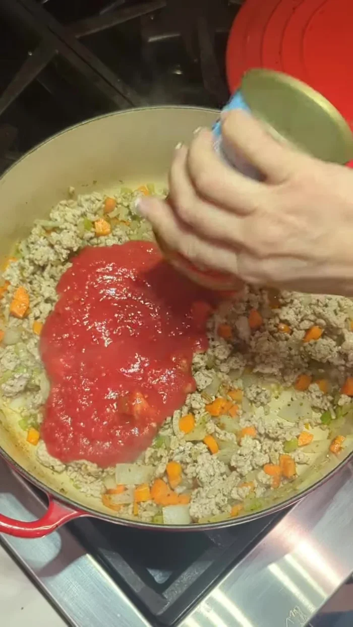 Add 14 oz can of crushed tomatoes, chicken broth (amount to your preference), and the pre-cooked beans (including their juice).