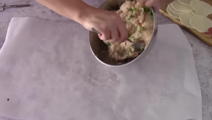 Spread the meat mixture on baking paper, forming a rectangle.