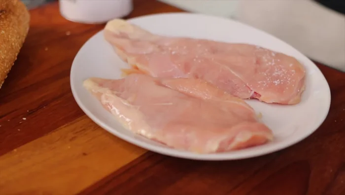 Season chicken cutlets with salt and pepper.