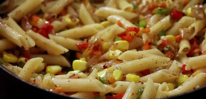 Mix the cooked pasta with the sautéed vegetables.