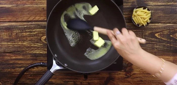 In a separate pan, melt 4 cubes of butter over low heat. Whisk in 3 tablespoons of all-purpose flour until smooth.