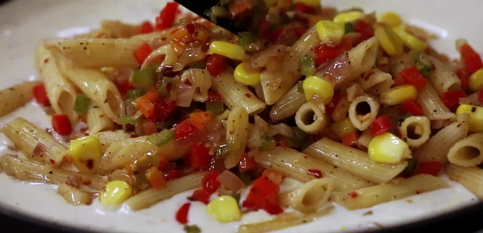 Combine the pasta and vegetable mixture with the creamy white sauce. Cook over low heat for about 5 minutes, ensuring everything is well coated.