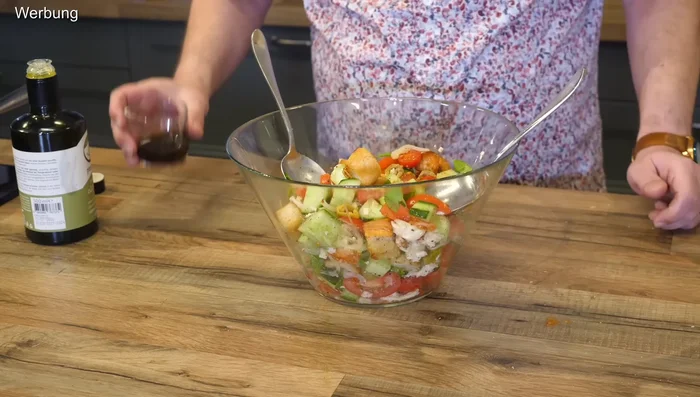 Dress the salad with balsamic vinegar and olive oil.