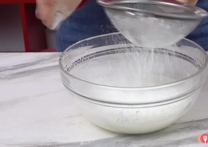 Combine the cornstarch mixture with the boiling milk mixture.