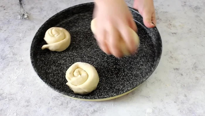 Place the swirls on a baking tray, cover with a tea towel, and let rest for 30-40 minutes.