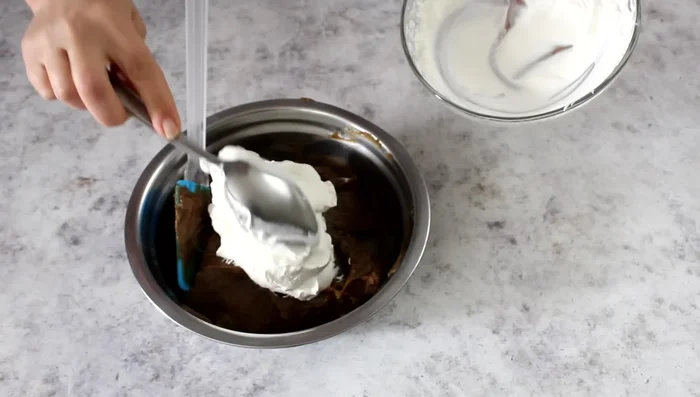 Whip the cream and fold it into the cooled coffee cream.