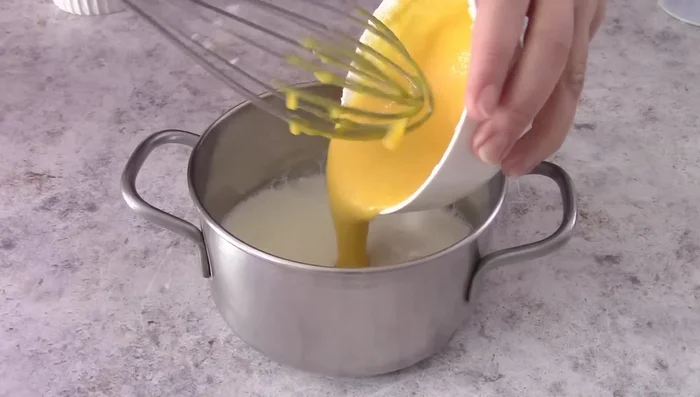 Cook the remaining milk with the egg yolk mixture until it thickens.