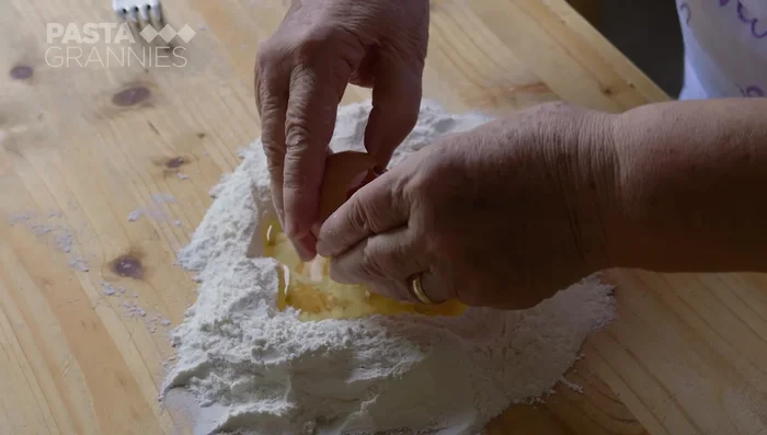 Make the pasta dough: Mix 100g of flour per egg, adding a tablespoon of olive oil. Knead for 5 minutes, then rest for 1 hour. (150.48)