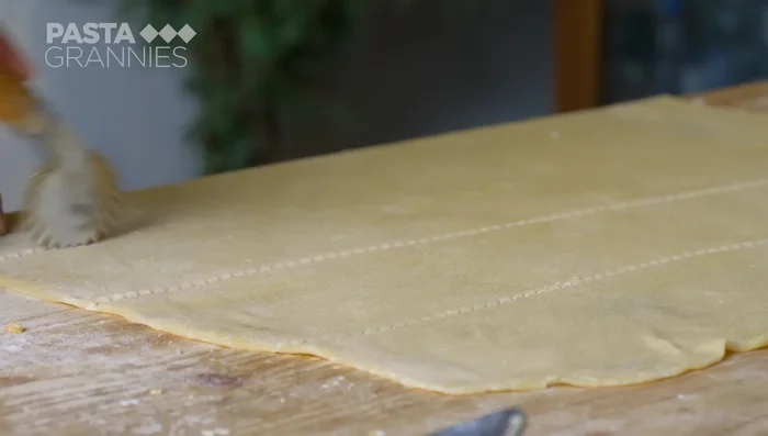 Roll out the pasta dough. Cut 10cm squares. Place a teaspoon of filling in the center of each square. (376)