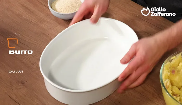 Butter a baking dish and sprinkle with breadcrumbs. Transfer the potato mixture into the dish, spreading evenly with a spatula.
