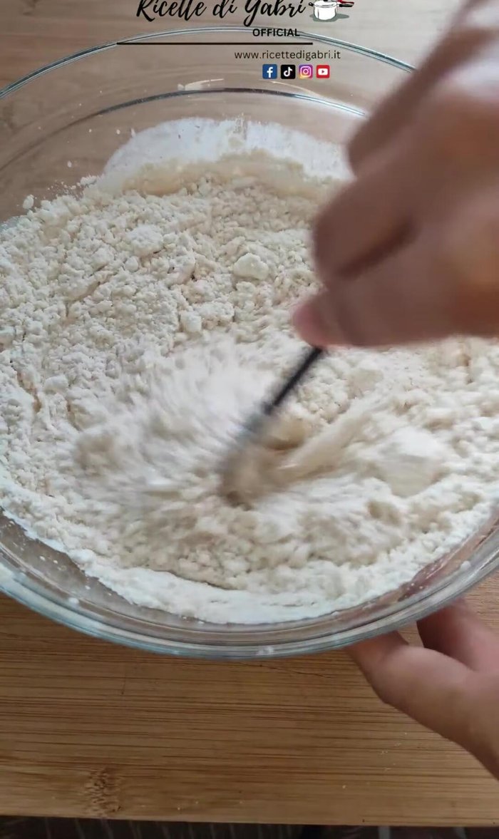 Add sugar, baking powder, raisins or chocolate chips, cinnamon, and almond flakes to the blended mixture.