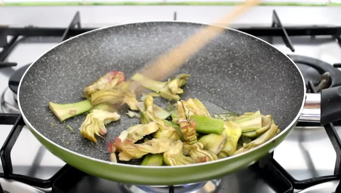 Add water, cover, and simmer for 15 minutes until artichokes are soft.