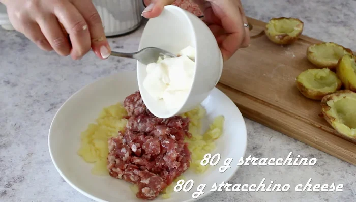 Mix the mashed potatoes with the sausage, stracchino cheese, salt, and pepper.