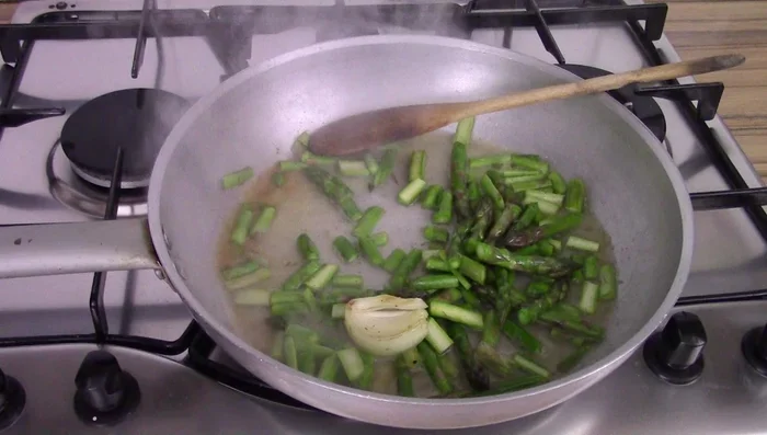 Add a little water to the asparagus, cover, and cook until soft.