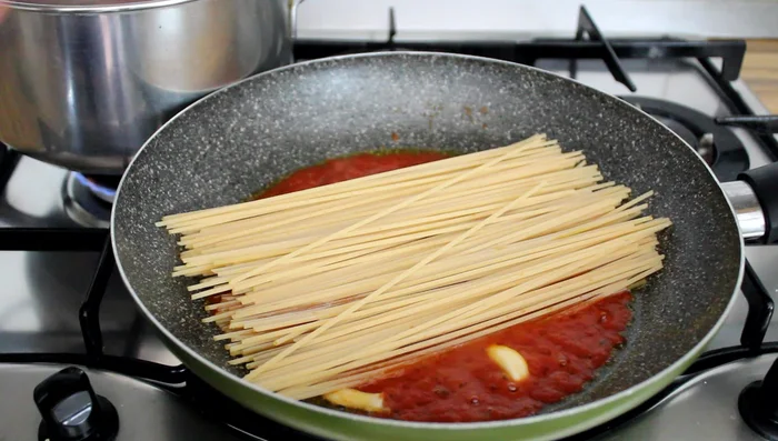 Toast the spaghetti over high heat without touching them initially. After a while, start turning them slowly, reducing the heat to prevent splattering.