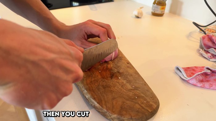 Peel and cut the shallot lengthwise, leaving the root intact.
