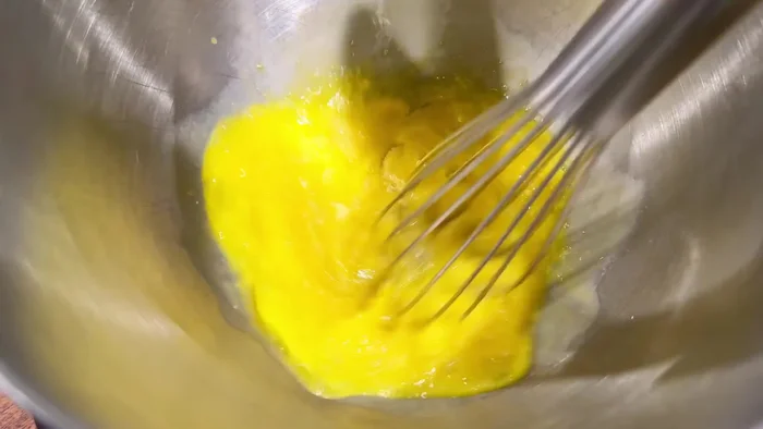 Add the warmed milk and butter mixture to the dry ingredients.