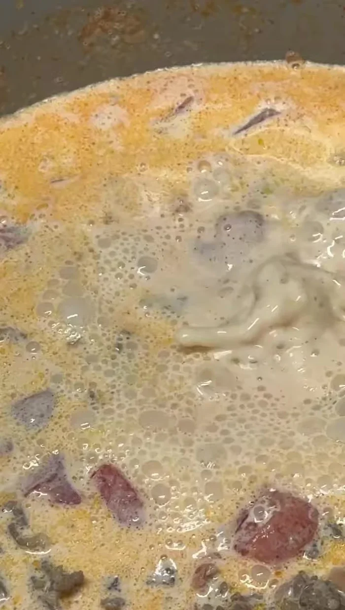 Add chicken broth and bring to a simmer.