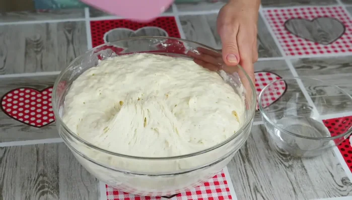 First kneading: Using a spatula or wet hands, gently lift and fold the dough from the sides to the center, repeating several times. This helps to retain air and create a porous texture. (270.759)