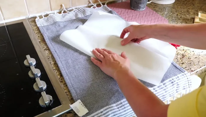 Prepare baking surface: Cut parchment paper into 15cm wide strips. Place strips on a towel-lined baking sheet. (587.519)