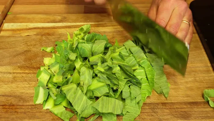 Slice green beans and cabbage. Add to the pan with the sautéed vegetables along with some water.