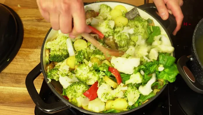 Add the partly cooked vegetables to the pan with the sautéed vegetables.