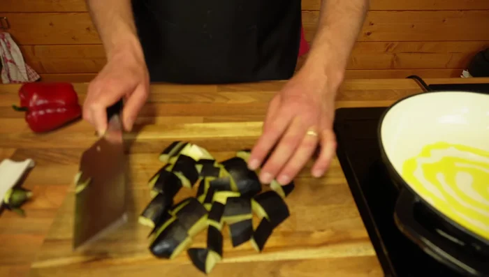 Cut eggplant into 1-inch strips. Add to a pan with olive oil and sauté.