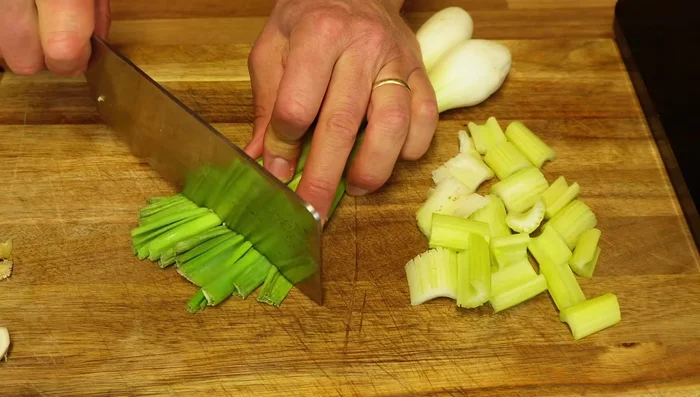 Prepare spring onions (remove ends), chop into similar size as celery and eggplant, add to the pan.