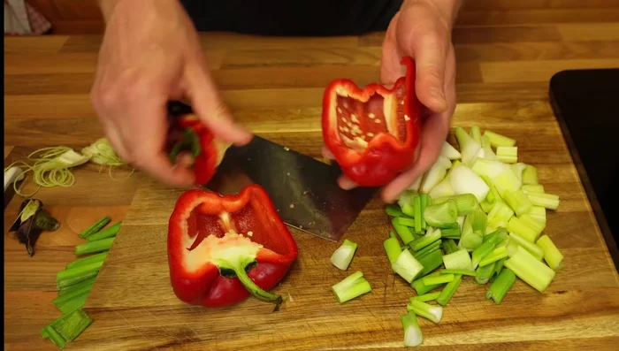 Prepare red pepper (remove seeds and white bits), chop into strips, add to the pan.
