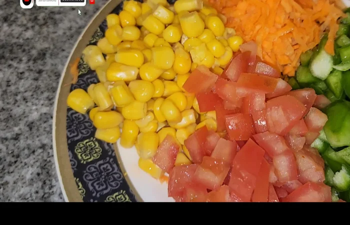 Cut capsicum, carrot, and tomato into small pieces.