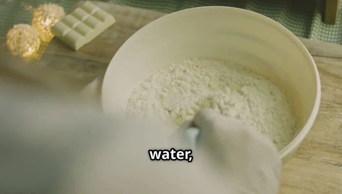 Mix dry dough ingredients (flour, sugar, salt, yeast). Slowly add cold water and olive oil, kneading until smooth and elastic (10 minutes by hand, 5 minutes in a stand mixer).