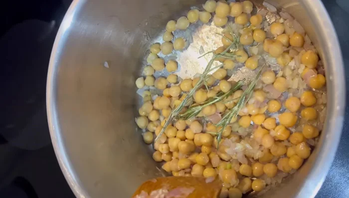 Add vegetable broth (or chicken broth) and pasta to the pot.