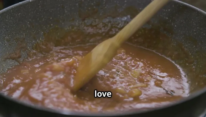 Finish the sauce: Stir in a drizzle of olive oil and a sprinkle of Parmesan cheese. Top with fresh basil leaves.