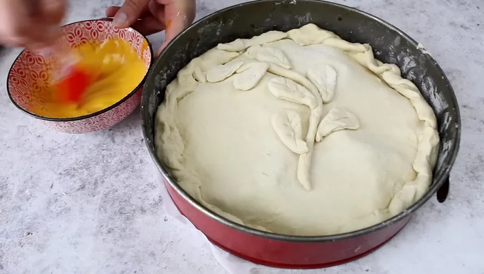 Brush the pie with egg yolk and milk mixture.