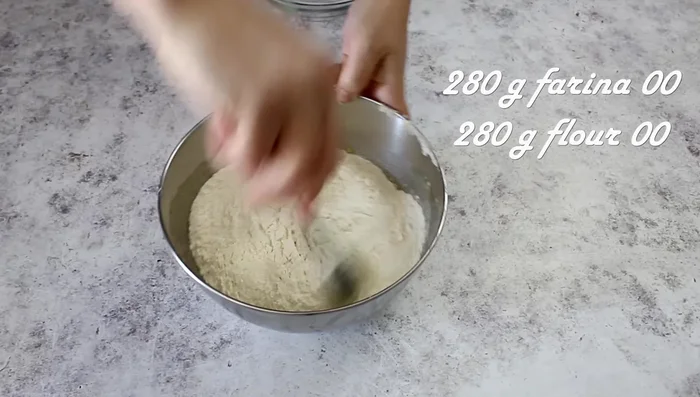 Gradually add the flour and mix in the bowl. Once the dough starts coming together, knead it on a floured surface until smooth. Keep your hands floured.